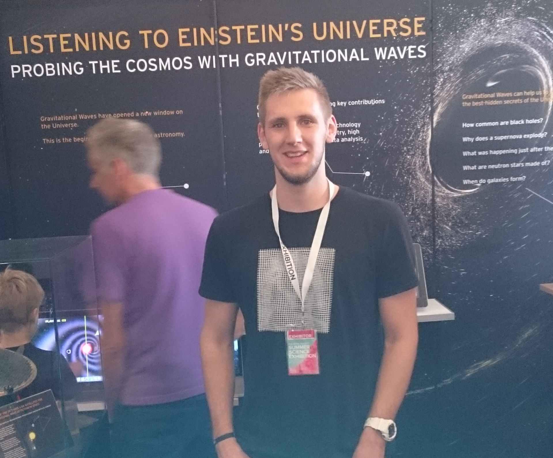 Person in front of black Gravitational Waves exhibit